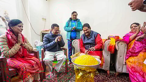 AAP national convener Arvind Kejriwal with his wife Sunita Kejriwal during a visit to the Marghat Wale Baba temple to launch the 'Pujari Granthi Samman Yojana', in New Delhi, Tuesday, Dec. 31, 2024.