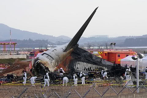 Rescue team members work at the site of a plane crash at Muan International Airport in Muan, South Korea, Tuesday, Dec. 31, 2024.