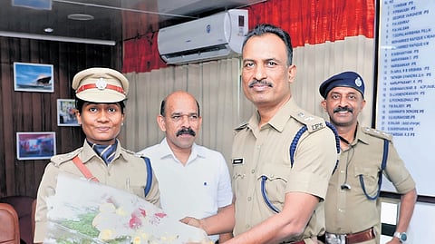Outgoing DCP K S Sudarsan presenting a bouquet to new DCP Aswathy Gigi.