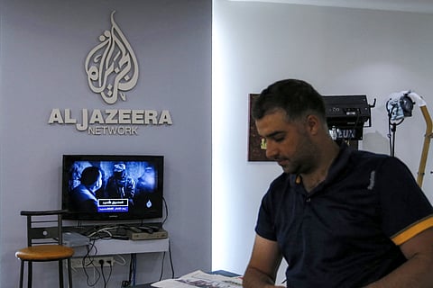 An employee of the Qatar based news network and TV channel Al-Jazeera is seen at the channel's Jerusalem office on July 31, 2017. The Palestinian Authority on January 1, 2025 ordered the suspension of broadcasts by the Qatar-based Al Jazeera across the Palestinian territories.