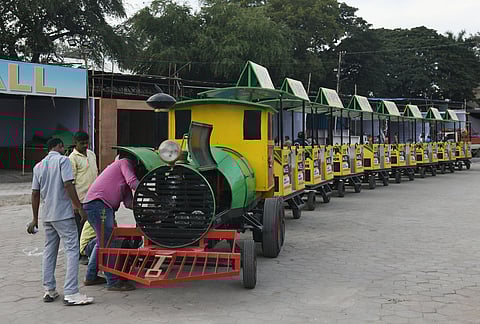 Workers repairing the vibrant Toy Train in preparation for the All India Industrial Exhibition at Nampally, Hyderabad