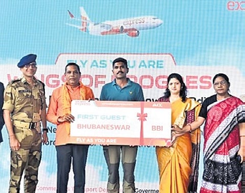 The first passenger being handed over a ticket by the guests at Biju Patnaik International Airport on Friday