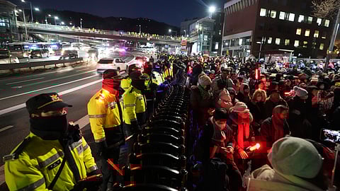 Supporters of impeached South Korean President Yoon Suk Yeol stage a rally to oppose a court having issued a warrant to detain Yoon, as police offices stand guard near the presidential residence in Seoul, South Korea.