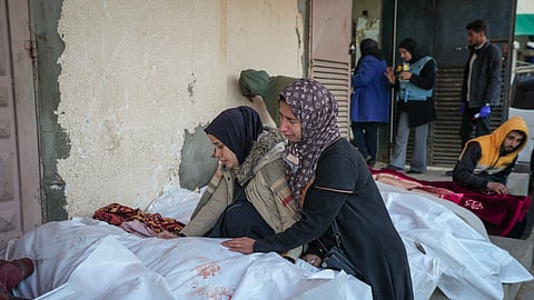 Relatives mourn over the bodies of victims of overnight Israeli army strikes at multiple locations in central Gaza Strip, at Al-Aqsa Martyrs Hospital in Deir al-Balah, Friday, Jan. 3, 2025.