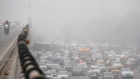 Vehicles move on the Delhi-Gurugram expressway amid low visibility on a foggy winter morning.
