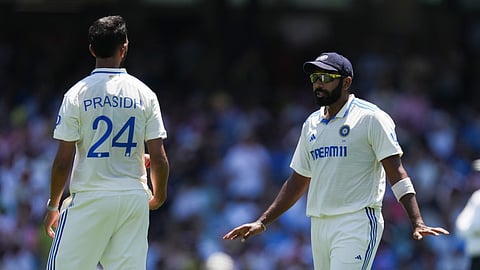 India's Jasprit Bumrah, right, talks with teammate Prasidh Krishna during play on the second day of the fifth cricket test between India and Australia.