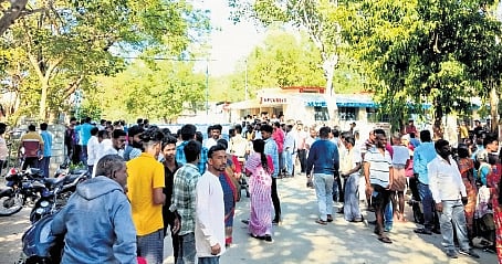 People gather at the Premier Explosives Company on the outskirts of Peddakandukuru in Yadagirigutta mandal, Nalgonda after the explosion