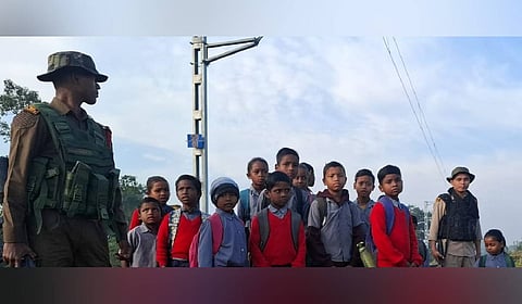 Forest Guard escorting the children to school.