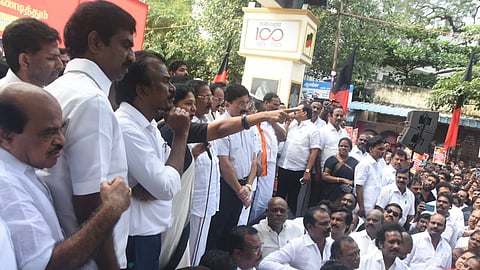 DMK leaders along with their party cadres staged a protest against governor RN Ravi for humiliating Tamilthai vaazhthu at Panagal Maaligai in Saidapet on Tuesday.