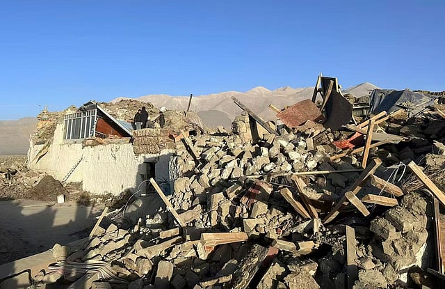 In this photo released by Xinhua News Agency, people stand amidst damaged houses in the aftermath of an earthquake in Tonglai Village, Changsuo Township of Dingri in Xigaze, southwestern China's Tibet Autonomous Region on Tuesday, Jan. 7, 2025.