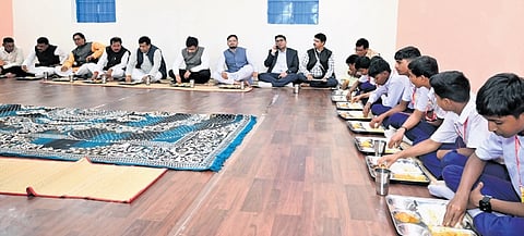 Majumdar and other leaders having mid-day meal in Malusaunta High School