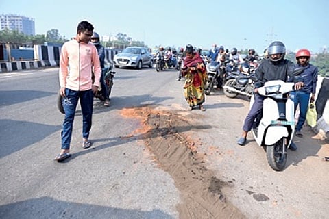 Commuters stop by the crime scene on Rasulgarh over-bridge