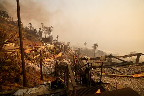 Homes damaged by the Palisades Fire are seen along the beach on Wednesday in Malibu, California.