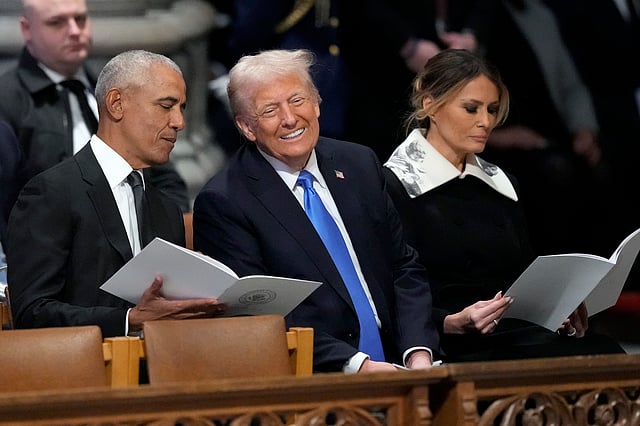 Former President Barack Obama talks with President-elect Donald Trump, next to Melania Trump, as they arrive to attend the state funeral for former President Jimmy Carter at Washington National Cathedral in Washington, Thursday, Jan. 9, 2025.