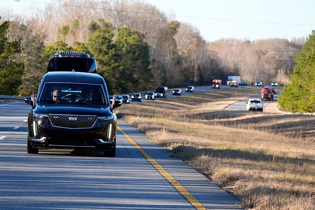 The hearse containing the flag-draped casket of former President Jimmy Carter travels in the motorcade from Lawson Army Airfield, in Fort Moore, Ga., to Maranatha Baptist Church in Plains, Ga., Thursday, Jan. 9, 2025.