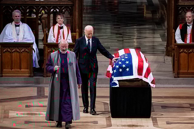 President Joe Biden touches the casket of former President Jimmy Carter after delivering remarks during Carter's state funeral at the National Cathedral, Thursday, Jan. 9, 2025, in Washington.