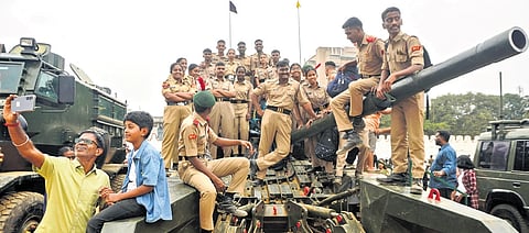 NCC cadets pose for a selfie atop a tank at ‘Know Your Army Mela’ organised as part of the 77th Army Day celebrations at Field Marshal Sam Manekshaw Parade Ground in Bengaluru on Saturday