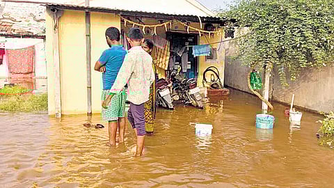 Water floods a colony at Mannepally village in Thimmapur mandal of Karimnagar district, following a breach to the canal on Sunday
