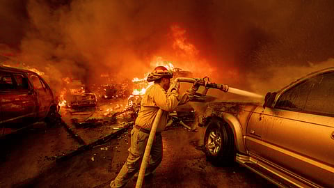 A firefighter battles the Eaton Fire Wednesday, Jan. 8, 2025, in Altadena, Calif.