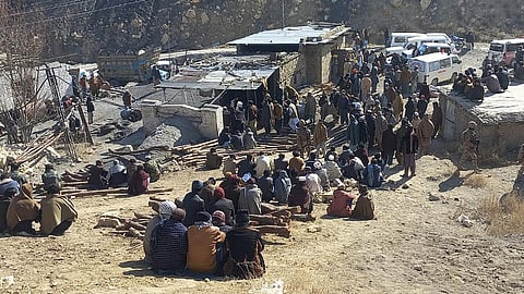 Local residents gather as rescuers conduct an operation to recover coal mine workers following a methane gas explosion caused a coal mine to collapse in Singidi, a remote area of southwest Pakistan’s Balochistan province