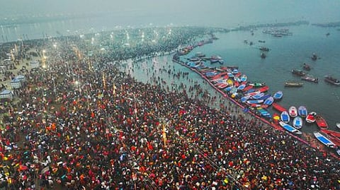Devotees take a holy dip at Sangam during Maha Kumbh Mela 2025.