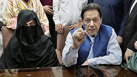 Pakistan’s former Prime Minister Imran Khan (R) with his wife, Bushra Bibi.