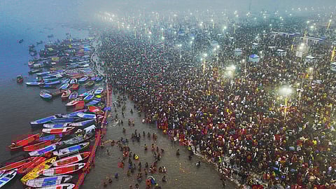 Hindu devotees arrive to bathe at the confluence of the Ganges, the Yamuna and the mythical Saraswati rivers on the first day of the 45-day-long Maha Kumbh festival in Prayagraj