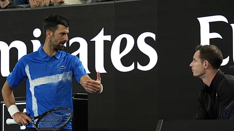 Novak Djokovic, left, of Serbia, talks with his coach Andy Murray during his first round match against Nishesh Basavareddy of the US at the Australian Open tennis championship in Melbourne, Australia, Monday, Jan 13, 2025.