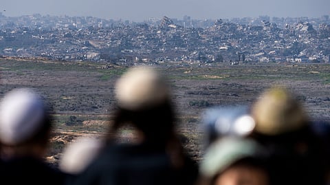 People watch the Gaza Strip from an observation point in Sderot, southern Israel, Monday, Jan. 13, 2025.