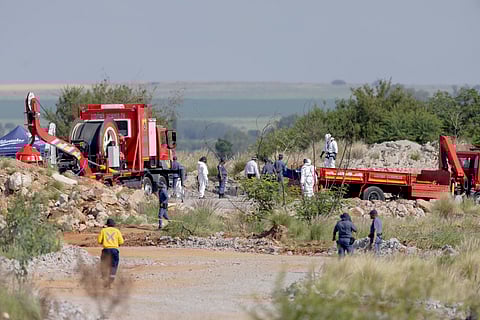 Rescuers and South African Police Service (SAPS) officers carry remains in blue body bags during a rescue operation to retrieve illegal miners from an abandoned gold shaft in Stilfontein on January 13, 2025.