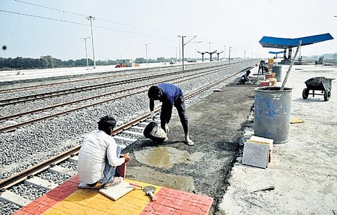 Workers lay tiles at the Kothapally railway station in Karimnagar district on Wednesday.