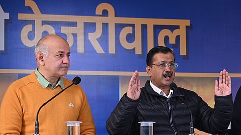 Aam Aadmi Party chief Arvind Kejriwal and party leader Manish Sisodia, left address a press conference, in New Delhi.