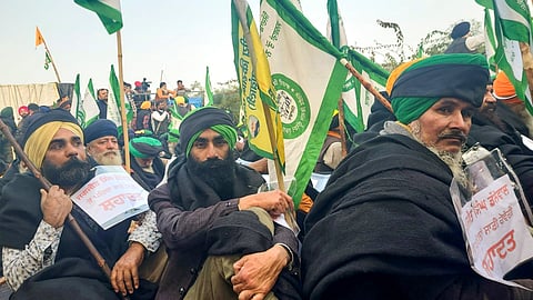 Farmers wear black clothes during their protest at the Khanauri border seeking a legal guarantee on the minimum support price (MSP) for crops, in Sangrur district, Wednesday, Jan. 15, 2024.