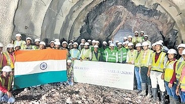 Workmen celebrate the completion of T3 digging in Nayagarh district
