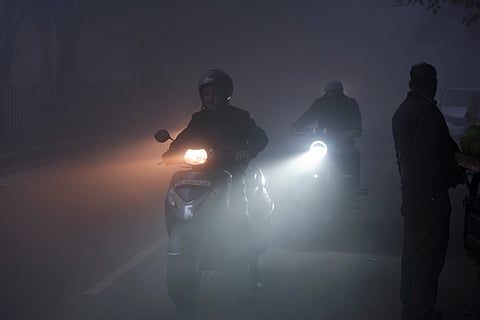 Commuters on a road amid dense morning fog, in New Delhi, Wednesday, Jan. 15, 2025.