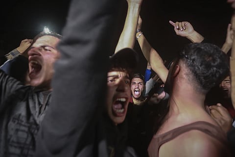 Palestinians celebrate the imminent announcement of a ceasefire deal between Hamas and Israel in Khan Younis, central Gaza Strip, Wednesday, Jan 15, 2025.