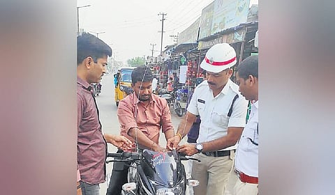 Kamareddy police set up safety wire on a two-wheeler to protect a rider from manja
