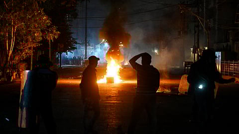 In this photo from Dec. 31, 2024, police personnel (front) disperse Shiite Muslim protesters during a demonstration to condemn sectarian clashes in Pakistan's Kurram district, bordering Afghanistan.