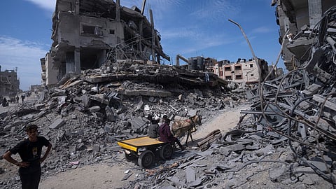 Palestinians salvage what they can from the destruction left by Israeli troops in Khan Younis, southern Gaza Strip, on April 8, 2024