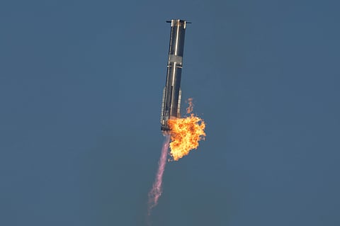 SpaceX's mega rocket Starship booster returns to the launch pad during a test flight from Starbase in Boca Chica, Texas, Thursday, Jan. 16, 2025.