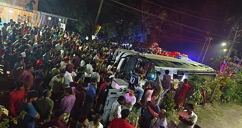 The tourist bus overturned in Irinchayam near Nedumangad in Thiruvananthapuram on Friday night.
