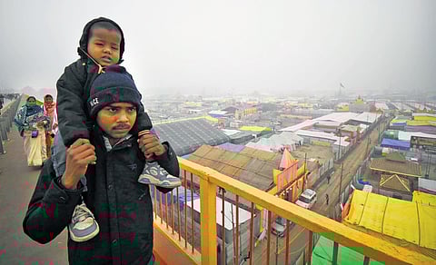 Devotees return after taking a holy dip at Maha Kumbh Mela in Prayagraj, Uttar Pradesh
