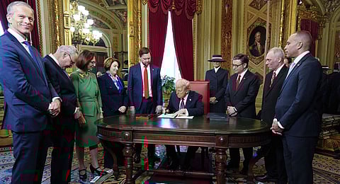 President Donald Trump, center, takes part in a signing ceremony in the President's Room after the 60th Presidential Inauguration, Monday, Jan. 20, 2025, at the U.S. Capitol in Washington.
