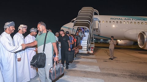 This image released by the state-run Oman News Agency shows the crew of the Galaxy Leader arriving in Muscat, Oman, after being released by Yemen's Houthi rebels on Wednesday, Jan. 22, 2025.