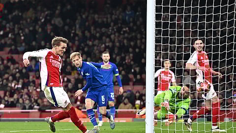 Arsenal’s Norwegian midfielde Martin Odegaard ()8) scores his team’s third goal during the UEFA Champions League football match between Arsenal and Dinamo Zagreb at the Emirates Stadium in north London on January 22, 2025.
