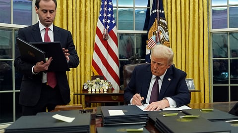 US President Donald Trump signs an executive order regarding the southern border in the Oval Office of the White House, Monday, Jan. 20, 2025, in Washington.