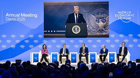 US President Donald J. Trump is shown on screens as he addresses via remote connection a plenary session in the Congress Hall, during the 55th annual meeting of the World Economic Forum (WEF), in Davos.