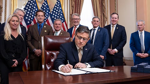 US House Speaker Mike Johnson puts his signature on the Laken Riley Act with members of the Georgia congressional delegation attending, at the Capitol in Washington, Thursday, Jan. 23, 2025.