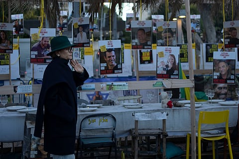 A woman looks at a display of empty chairs representing hostages held by the Hamas militant group in the Gaza Strip in Tel Aviv, Israel, Friday.