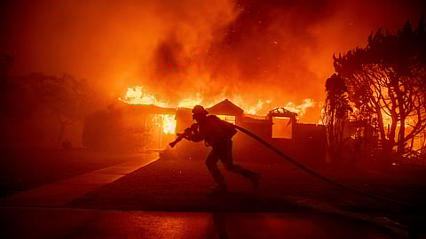 A firefighter battles the Palisades Fire as it burns a structure in the Pacific Palisades neighbourhood of Los Angeles, Jan. 7, 2025.